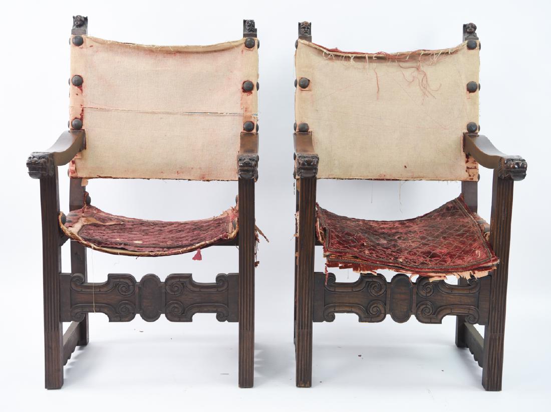 19TH C. RENAISSANCE STYLE CARVED WALNUT CHAIRS: Pair of armchairs. Lion head ends on armrest. Faces at tops of the sides. Upholstered with antique velvet and large brass tacks. Dimensions: H 46" x W 26.75" x D 22" x SH 20" Condition: Upholstery wor