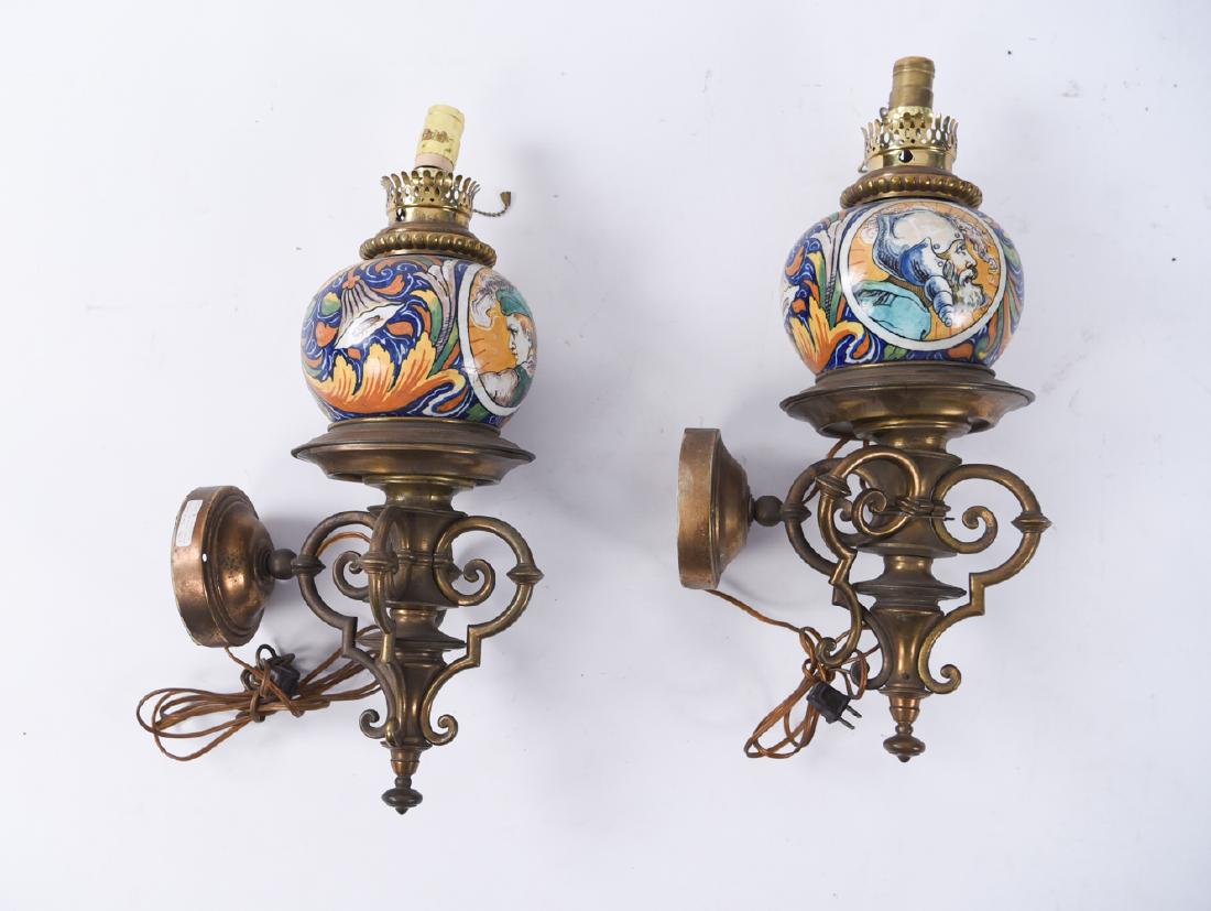 PAIR OF CERAMIC AND BRONZE SCONCES: Dimensions: H 23" x W 8" x D 11.5" Condition: Wear and tarnishing to metal. May need to be re-wired. One socket in need of repair. Surface dirt. Some loose elements.