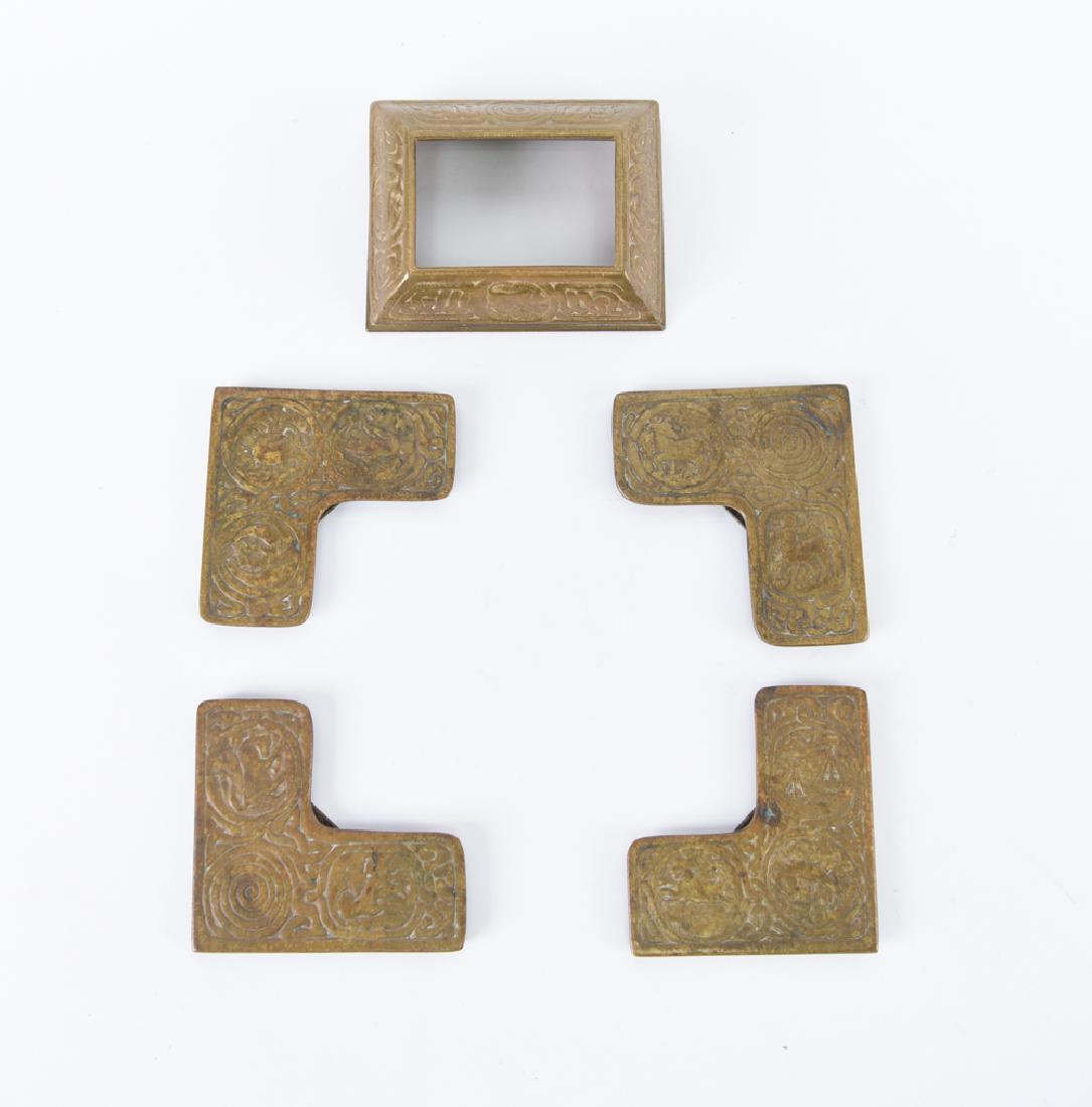 TIFFANY STUDIOS ZODIAC BLOTTER CORNERS & CALENDAR: Calendar marked: Tiffany Studios 929. Blotter corners marked: Tiffany Studios New York. Dimensions: (Calendar) H 1.5" x W 4.5" x D 3.5" Condition: Showing light signs of use. Some finish wear to corne