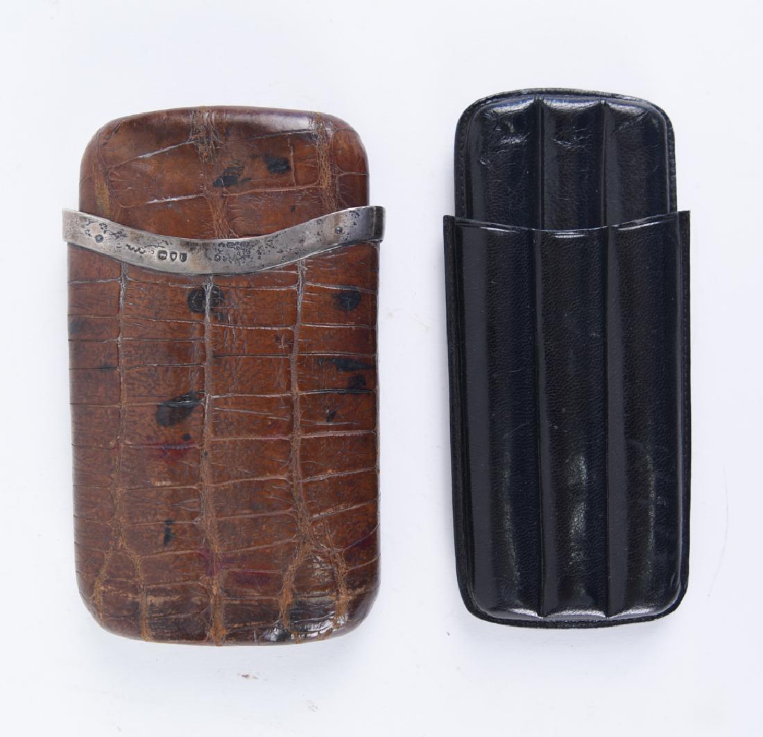 (2) ANTIQUE LEATHER CIGAR CASES: Hallmarked to sterling trim of one. Dimensions: (Larger) H 5.25" x W 3.5" x D 1" Condition: Showing light wear consistent with age and use.