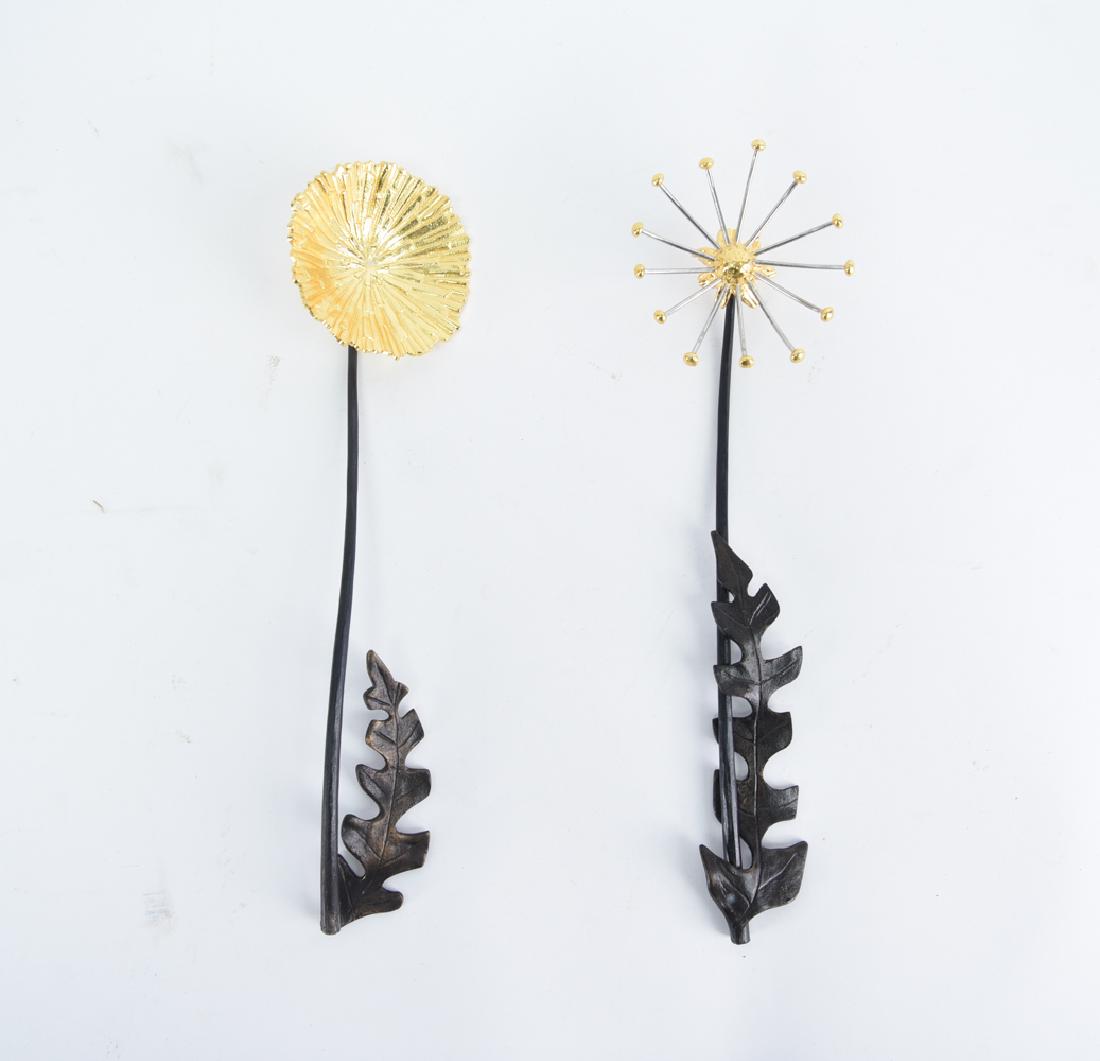 MICHAEL ARAM SERVINGWARE: Marked on leaf of one utensil. Dimensions: (One utensil) L 12.5" x W 3.5" Condition: Leaf weld on one utensil is broken.