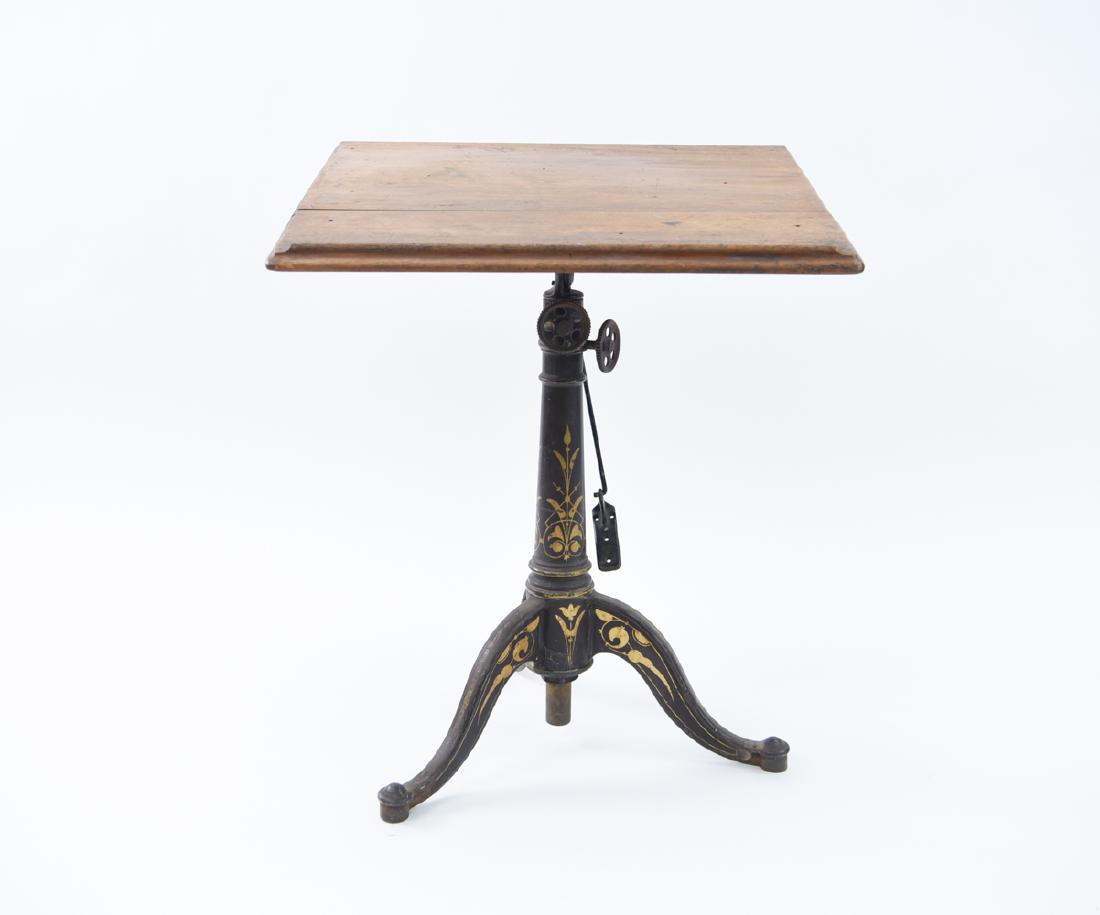 19TH C. INDUSTRIAL DRAFTING, WRITING TABLE: Paint decorated iron base, wooden top. Dimensions: (Top vertical) H 38" x W 25.5" x D 18" Condition: Wood split in half. Some age wear to painted surface.