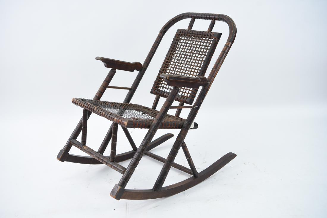 HUNZINGER ROCKING CHAIR: Dimensions: H 32" x W 22" x D 28" x SH 15" Condition: Rubbing, wear, loss to surface. Loss of fabric around banding.
