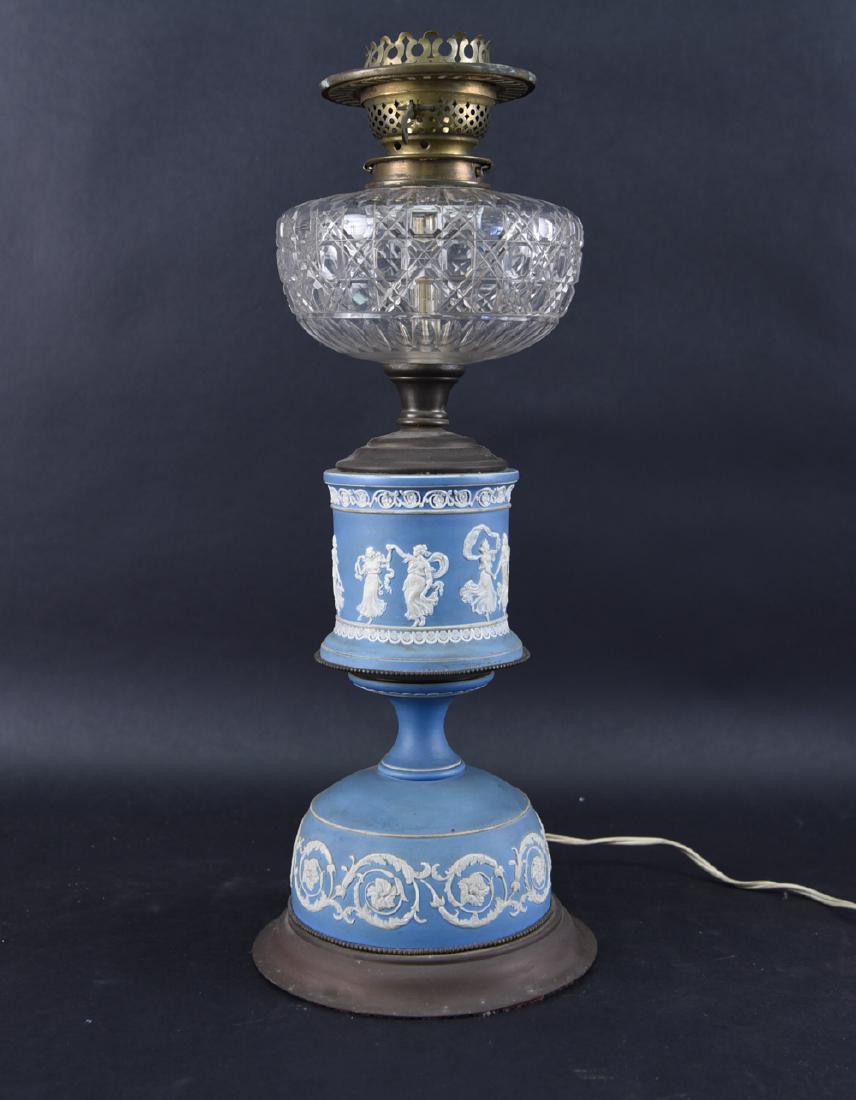 WEDGWOOD OIL LAMP: Dimensions: H 20" x Dia. 7.25" Condition: Needs to be rewired. Surface dirt. Flea bites to glass.