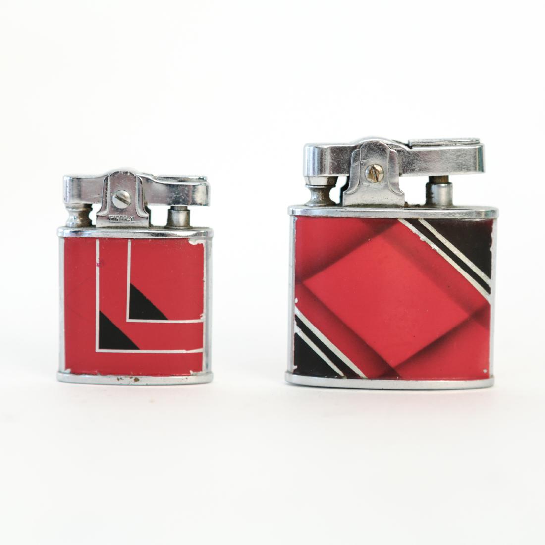 (2) ENAMELED ART DECO LIGHTERS: Including Firefly and Crown lighters Dimensions: (Larger) H 2" x W 1.52" x D .5" Condition: Showing light wear consistent with age and use. Few small chips to enamel.