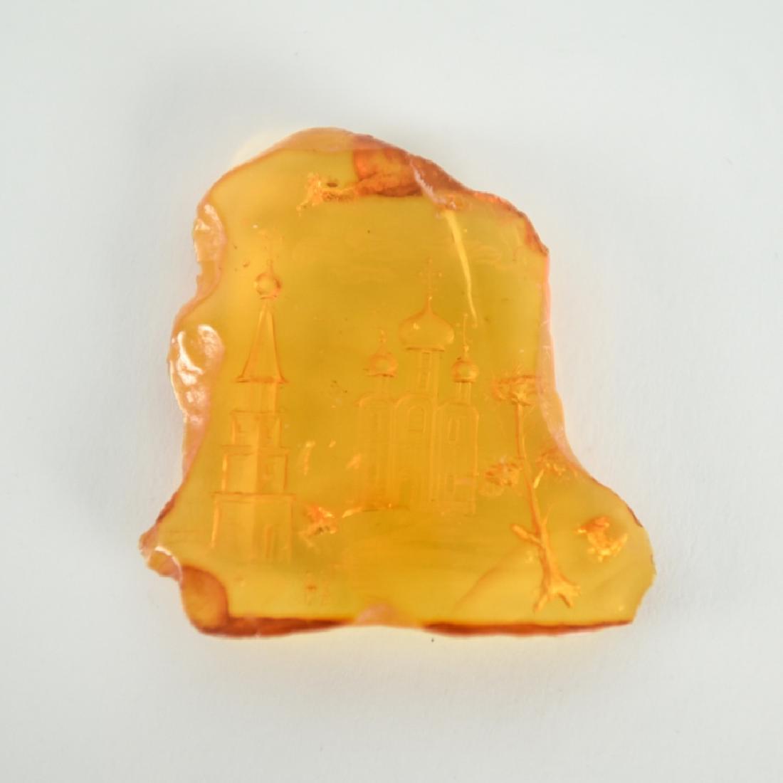 INTAGLIO CARVED BALTIC AMBER RUSSIAN SCENE: Unsigned reverse carving depicting a Russian church scene. Dimensions: L 2" x W 1.75" Weight: 7.2 grams Condition: no issues to note