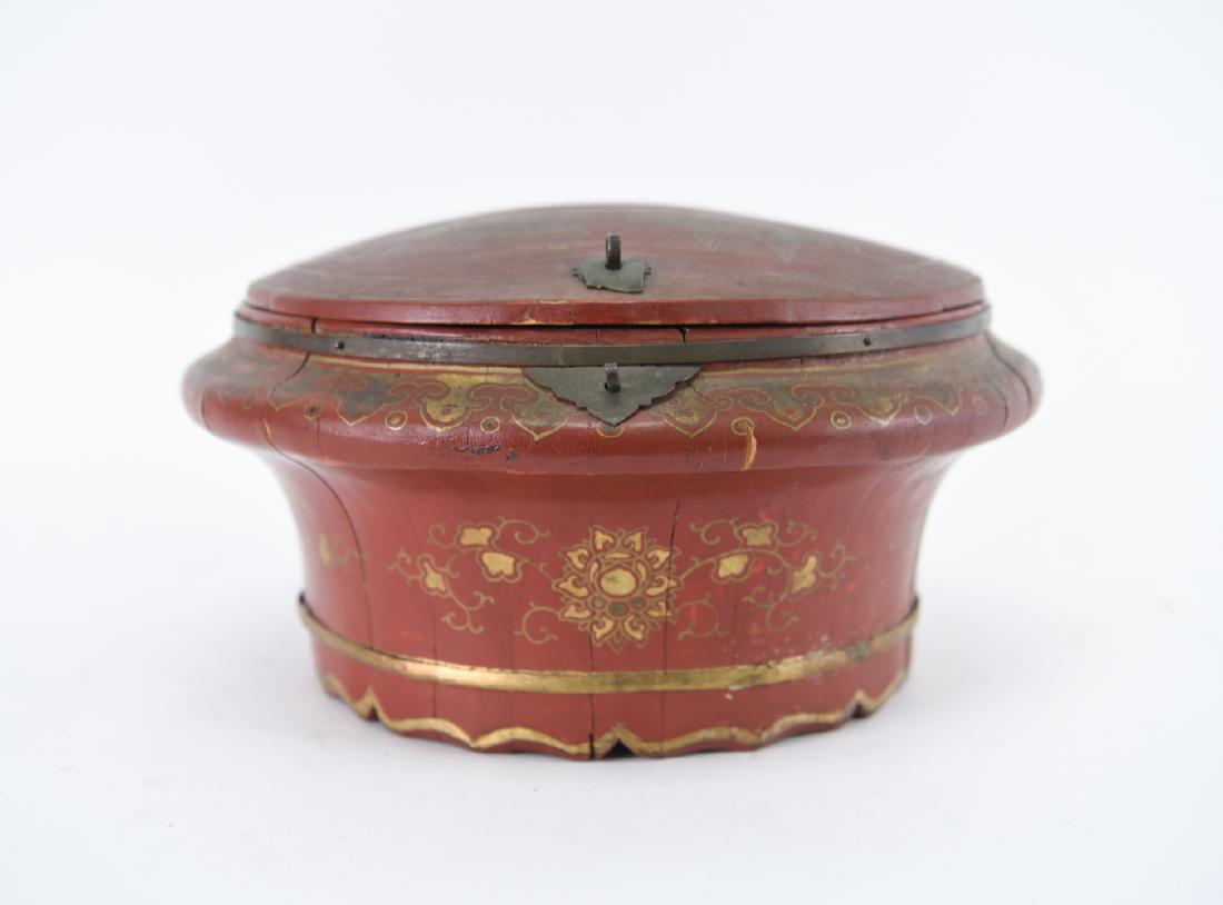 CHINESE LACQUERED BOX: 20th century. Red box with design in gold. Dimensions: H 7.5" x Dia. 12" Condition: Top split in half, with other splits. Metal lock broken. Top discolored.
