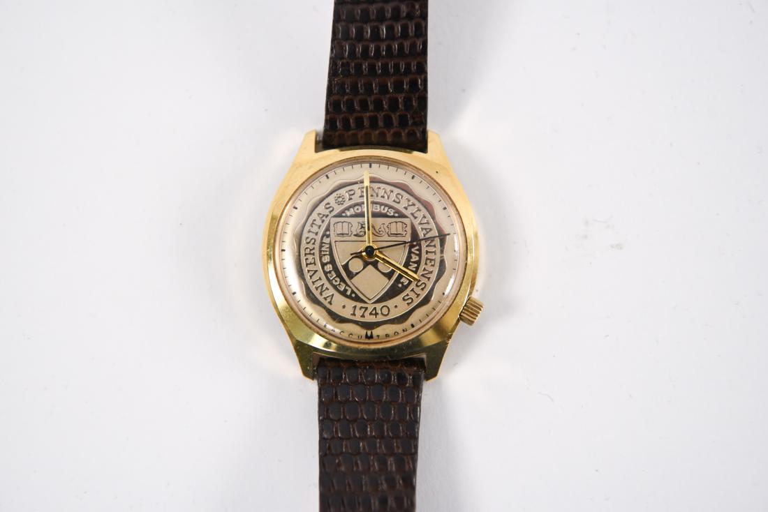 BULOVA ACUTRON UNIVERSITY PENN WATCH: With crest to dial. Dimensions: L 8" x W 1.5" Condition: Not tested for timekeeping. Very light wear consistent with use. Provenance: From a Greenwich, CT estate.
