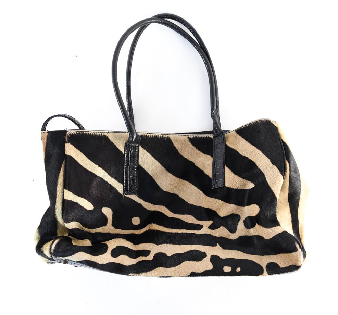 MAURIZIO TAIUITI FAUX ZEBRA BAG: Marked inside. Dimensions: (Incl. handles) H 20" x W 16.25" x D 6.5" Condition: Some surface discoloration and wear from age and use.