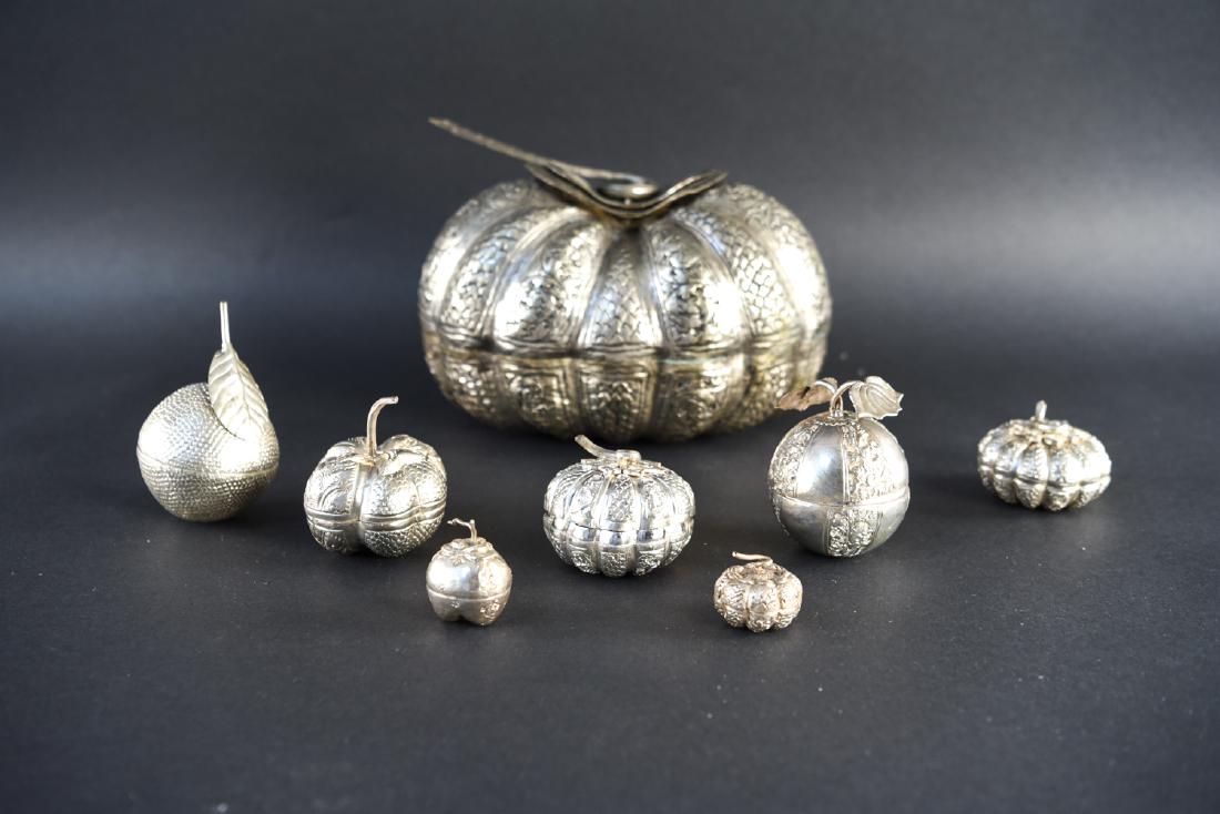 ASIAN HAMMERED & CHASED METAL CONTAINERS: With six smaller containers within. Dimensions: H 7" x W 10" x D 7" Condition: Lid does not fit properly. Some bends and dings.