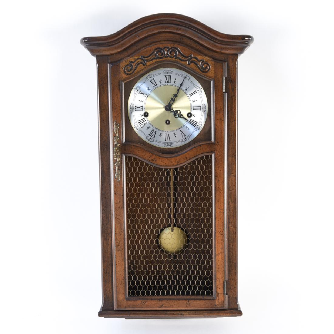 VINTAGE WALL CLOCK: Includes clock key. Dimensions: H 26.5" x W 14.25" x D 6.25" Condition: Not tested. Few minor nicks and dings to case.