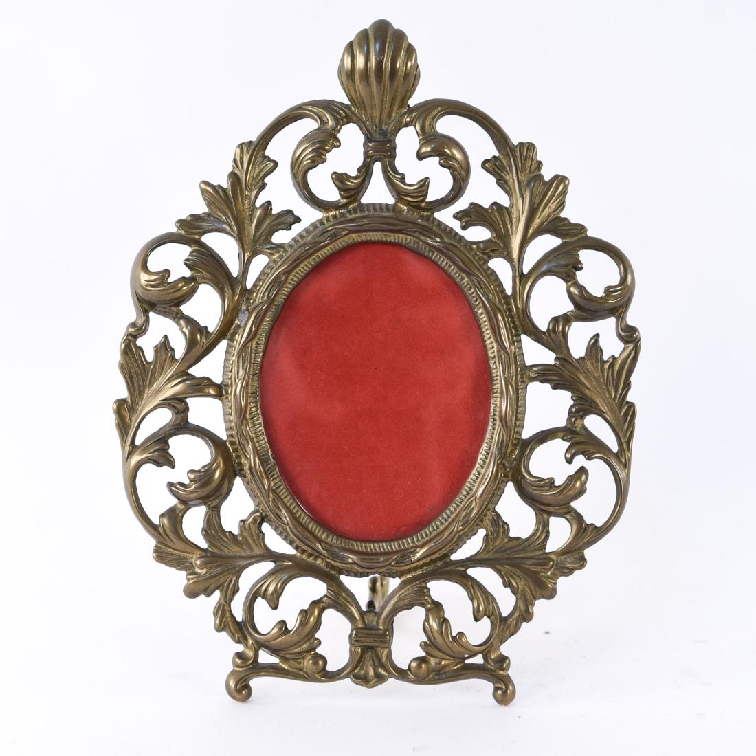 ANTIQUE BRASS MIRROR: 18th century foliate form. Dimensions: (Standing) H 10.75" x W 8" x D 4" Condition: Some surface wear.