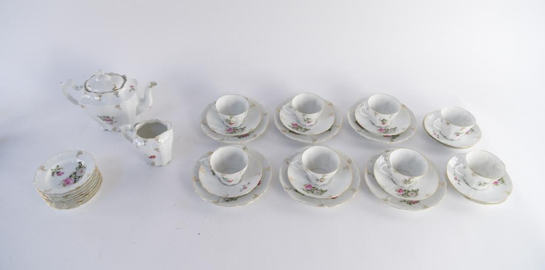PORCELAIN TEA SERVICE: Dimensions: (Kettle) Dimensions: H 7.5" x W 11" x D 5.5" Condition: Small chip to kettle spout. Couple flea boss to tea cups. Few hairline cracks to some dishes. Provenance: From a Greenwich, CT estat