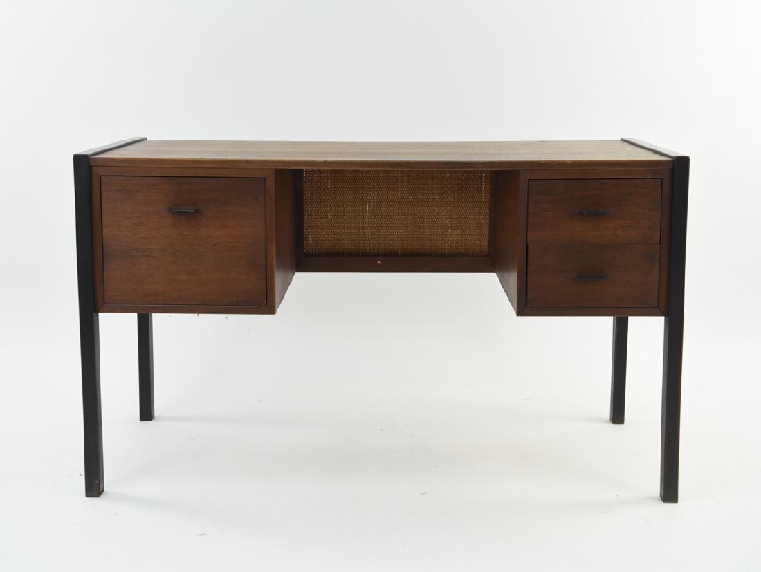 JACK CARTWRIGHT FOUNDERS WALNUT DESK: Dimensions: H 29.25" x W 50" x D 22.75" Condition: Showing very light wear overall. Some areas with light finish wear and marks. Some breaks to woven panel on verso.