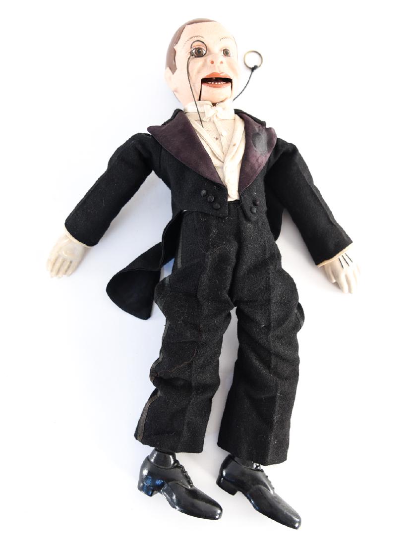 1938 CHARLIE MCCARTHY VENTRILOQUIST DOLL: By Effanbee. Dimensions: H 18.5" x W 7.5" x D 4" Condition: Crazing to face. Some marks and wear to paint. Age discoloration to clothing. Tear to one leg at ankle.