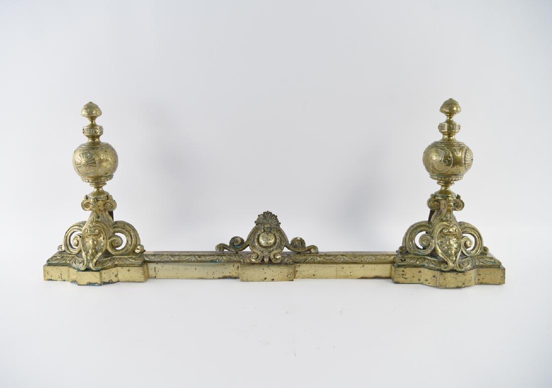 ANTIQUE FRENCH BRASS CHENET ANDIRONS: Dimensions: H 16.5 x (Greatest width) W 45" x D 6" Condition: Showing brass finish wear including areas of pitting and patina.