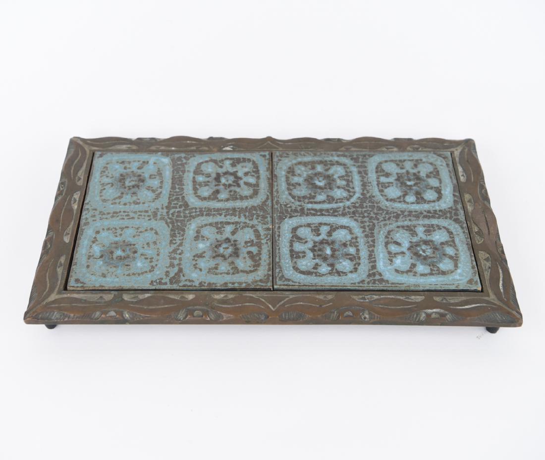 MID-CENTURY BRONZE AND TILE DOUBLE TRIVET: Tiles marked Hoffman, USA. Bronze unmarked. Dimensions: L 14" x W 8.5" x H 1.5" Condition: Some wear to tiles.