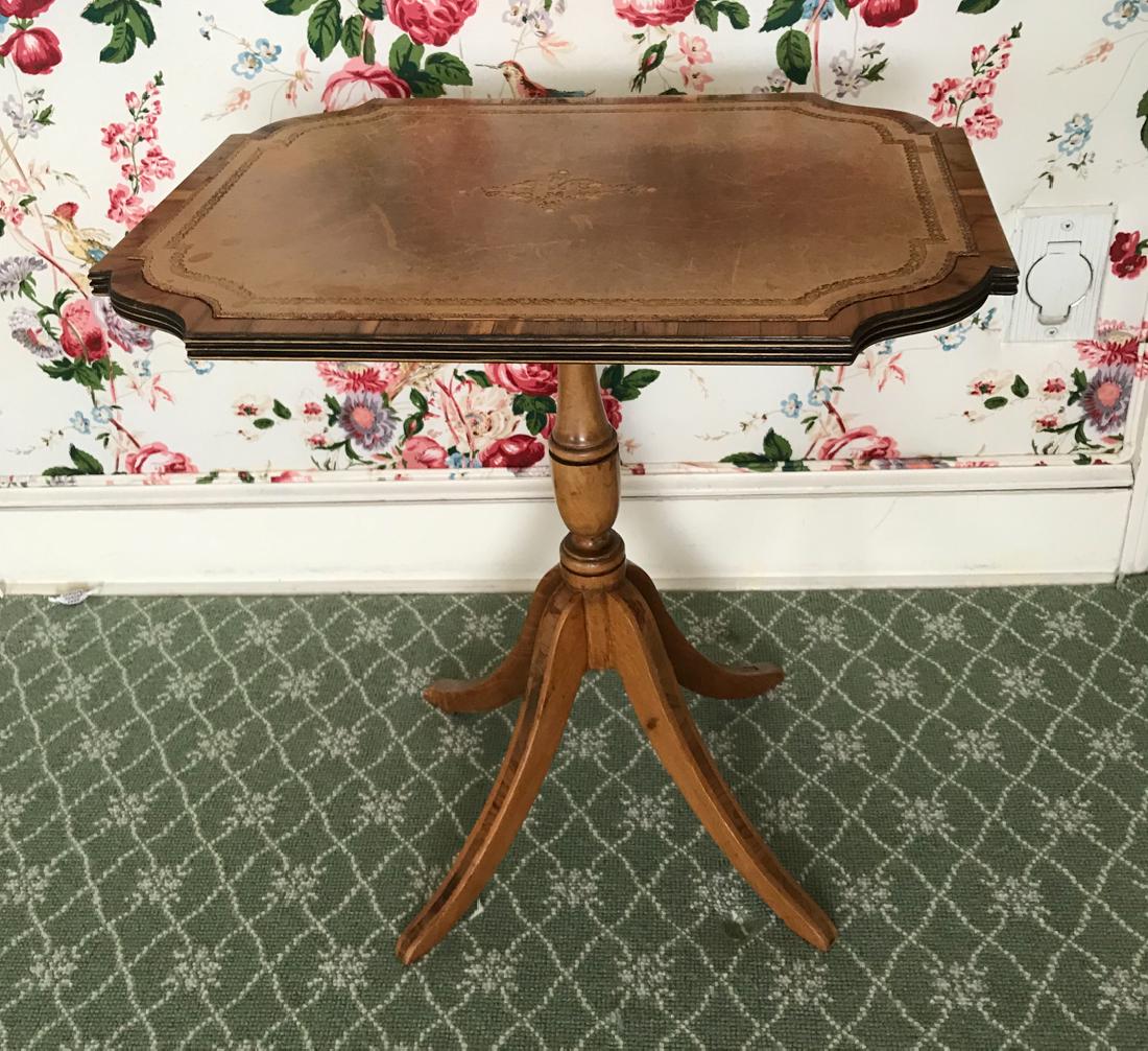 LEATHER TILT TOP SIDE TABLE: Leather top. Dimensions: H 20.5" x W 19.5" x D 14.75" Condition: Some discoloration and scuffs to leather. Wear consistent with age and use.