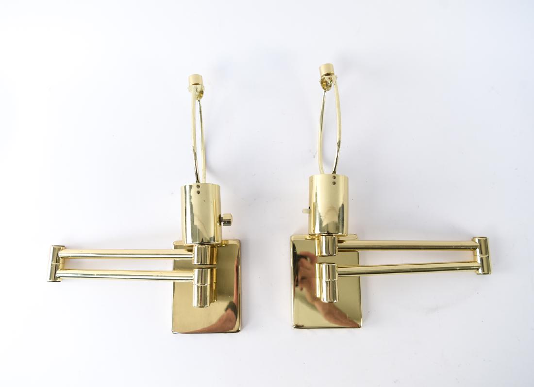 PAIR OF BRASS SWING ARM SCONCES: Marked Hinson, Made in Spain. Dimensions: (Closed) H (to finial) 13.5" x W 10" x D 2.75" Condition: Showing some light wear consistent with age and use. Few marks.