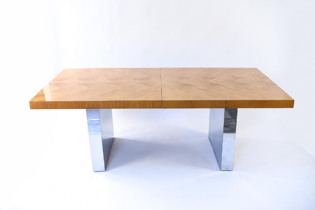 MILO BAUGHMAN THAYER COGGIN BURL & CHROME TABLE: c. 1970s. Figured wood top, chrome clad base. Dimensions: H 28" x L 78" x W 40" Condition: Small dents and scuffs to base, light surface scratches to table top.