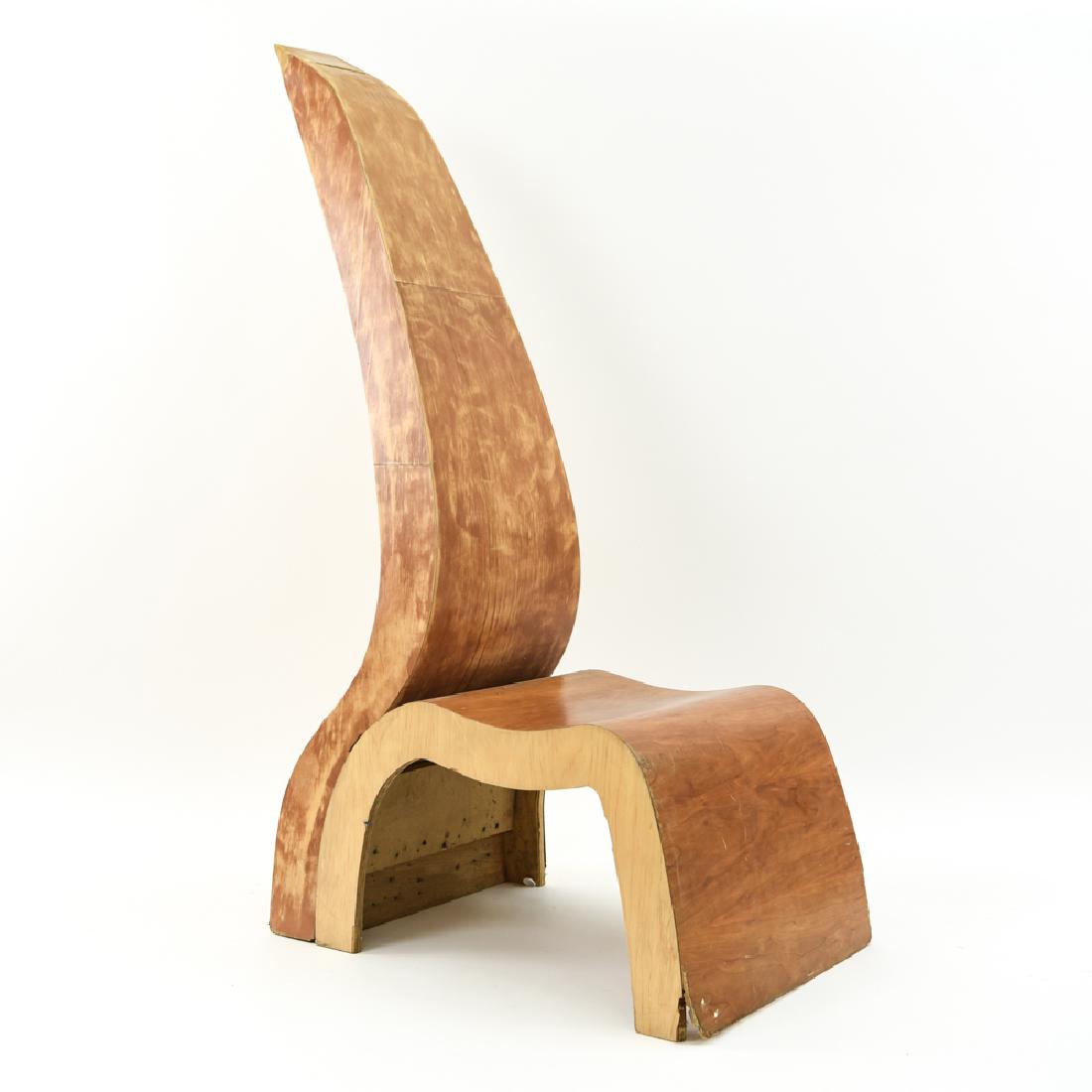 SCULPTURAL BENTWOOD LOUNGE CHAIR: Dimensions: H 60" x W 24" x D 34" x SH 16.5" Condition: Right front corner separating from base. Veneer loss in areas. Scratches, scuffs throughout. Repair at top right edge. Veneer buckling in areas.