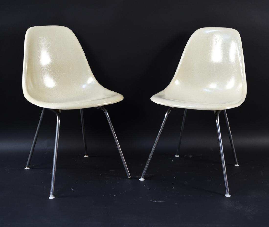 (2) EAMES FIBERGLASS SHELL CHAIRS: Marked original Eames fiberglass chairs on foil label on one. Other one without label, possibly in style of Eames. Dimensions: H 31" x W 19" x D 17" x SH 17" Condition: Scuffs to edges, normal signs o
