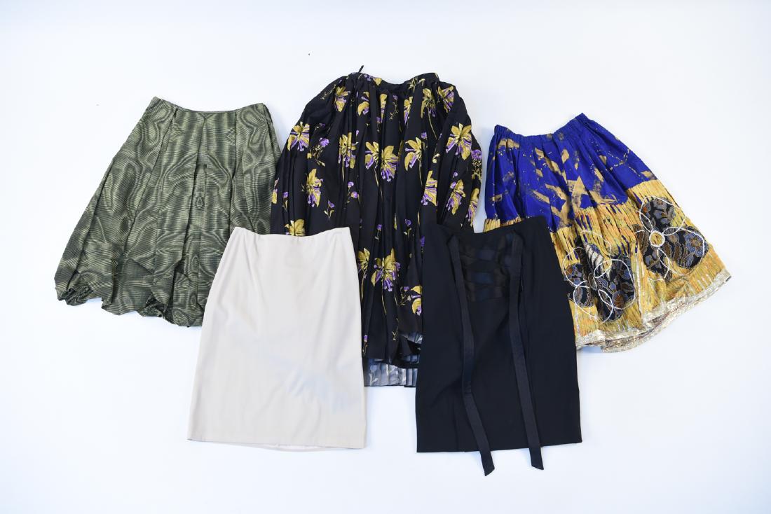 LADIES DESIGNER SKIRT GROUPING: Including: Makola black tool skirt, Ralph Lauren, Yves Saint Laurent black pencil skirt with satin bow, Prada (size 42) black floral skirt, Prada (size 40) green pattern skirt. Condition: Very lightly