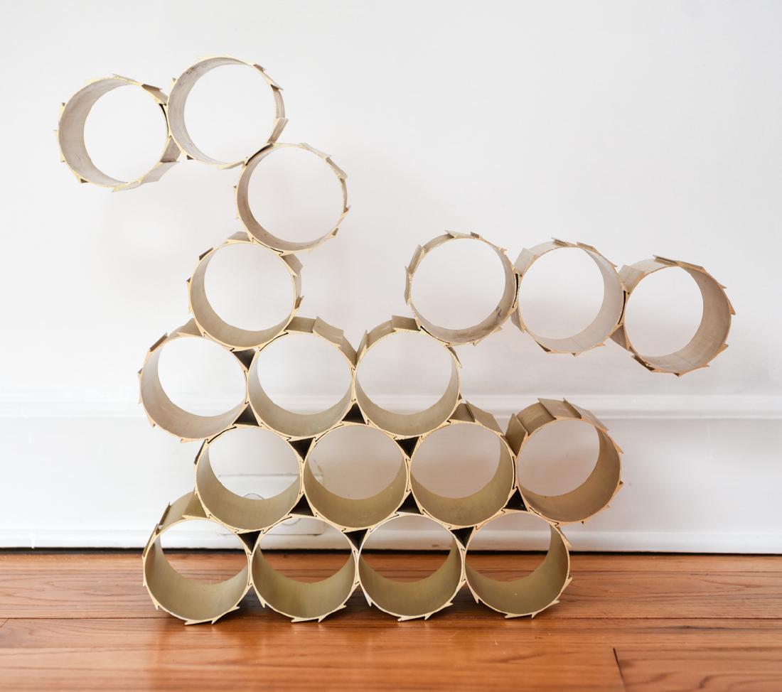 SET OF MODERNIST INTERLOCKING WINE BOTTLE HOLDERS: For eighteen bottles. Multiple configurations. Dimensions: (Each cylinder sleeve) H 5.75" x Dia. 4" Condition: Showing light scratches, rubs, and surface dirt.
