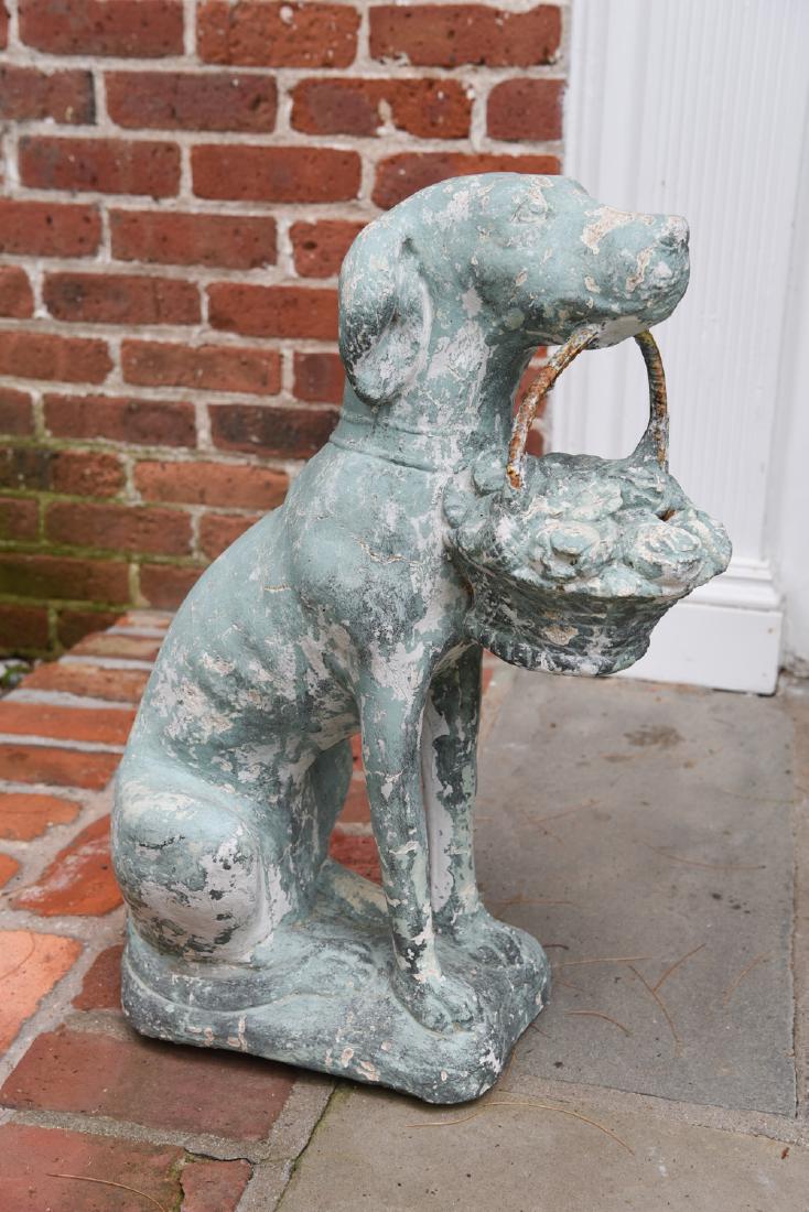 ANTIQUE CAST DOG WITH BASKET: Old painted surface. Dimensions: H 24" x W 8" x D 18" Condition: Wear consistent with outdoor exposure.