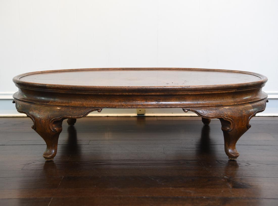 LARGE OVAL VINTAGE COFFEE TABLE: Rustic oak finish. Dimensions: H 17" x W 60" x D 40" Condition: Some light areas of finish wear including a few scratches and dings.