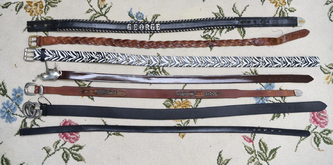 GROUPING OF DESIGNER BELTS: Including two Gucci belts. Dimensions: (Longest) L 43" Condition: Showing light signs of use. A couple with some moderate wear and warping of leather.