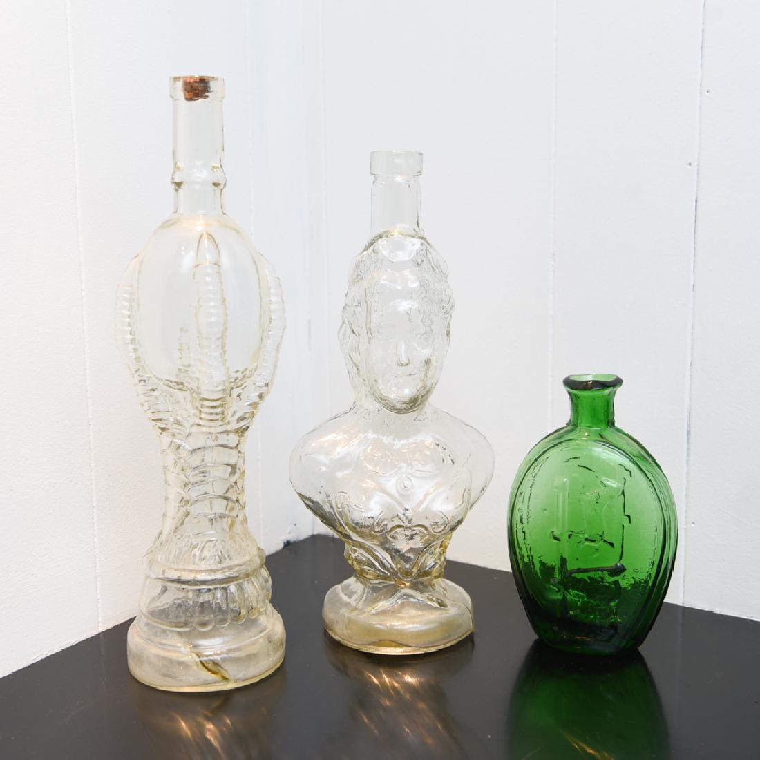 (3) ANTIQUE / VINTAGE BOTTLES: Two for alcohol. Dimensions: (Largest) H 14.25" x W 4" Condition: Surface dirt. Light signs of use.