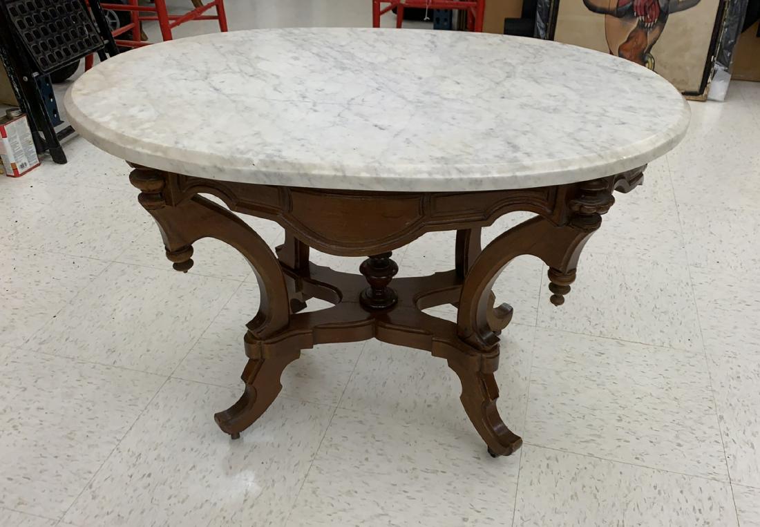 MARBLE TOP SIDE TABLE: Dimensions: H 21.75" x W 31" x D 23" Condition: Finish wear to wood. Chips to edges and surface scratches to marble. Old repairs and loss to wood. Some discoloration to marble.