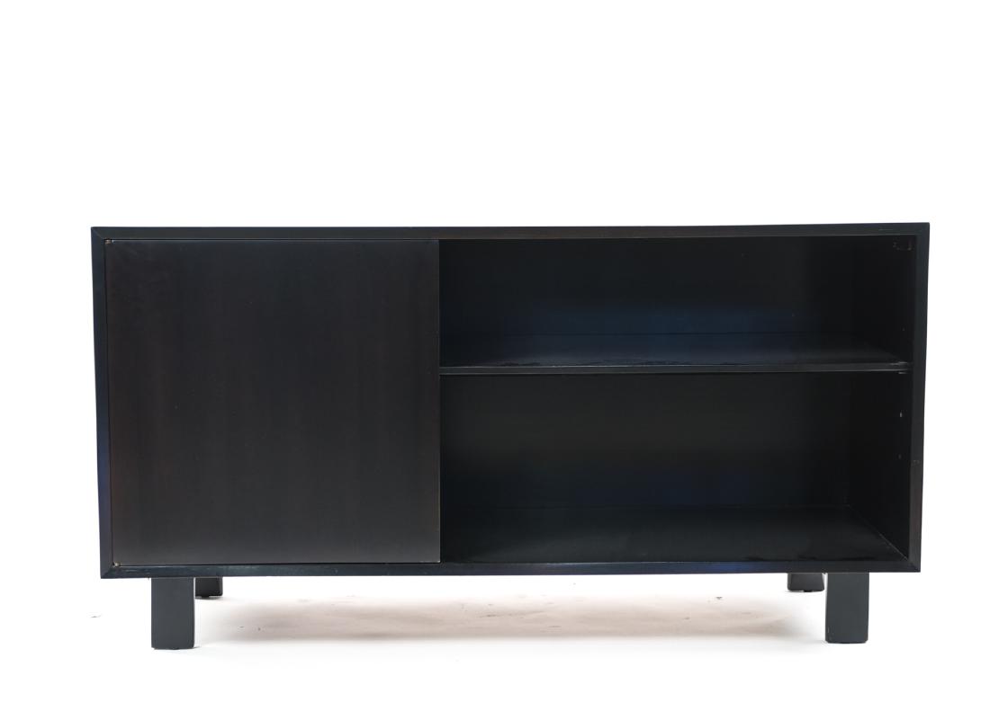 GEORGE NELSON FOR HERMAN MILLER CABINET: Original label covered by new finish.Dimensions: H 29.75" x W 56.25" x D 18.5"Condition: Scratches, scuffs, surface wear. Tape and veneer loss to patch in interior. Wear consistent with age and use. R
