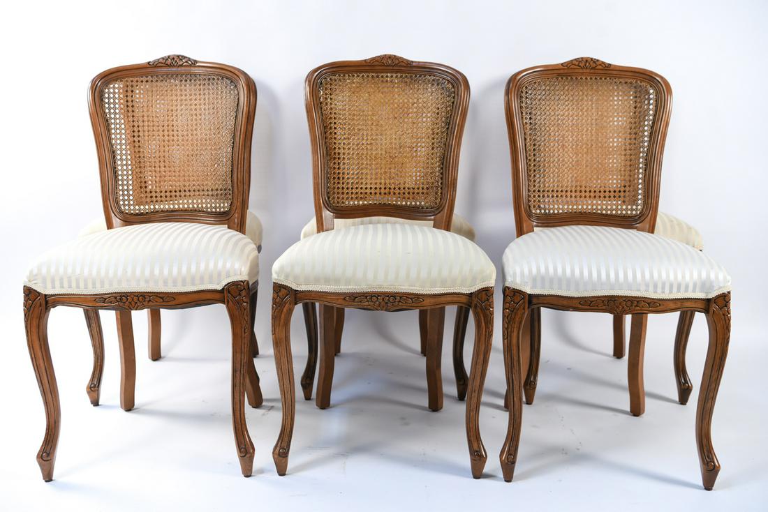 (6) ITALIAN CARVED & CANED DINING CHAIRS: Metal plaque underneath marked: made in Italy. Dimensions: H 37" x W 19" x D 22" x SH 20" Condition: Wear to finish on caning. No serious breaks. Some staining to fabric. Wear consistent with use.