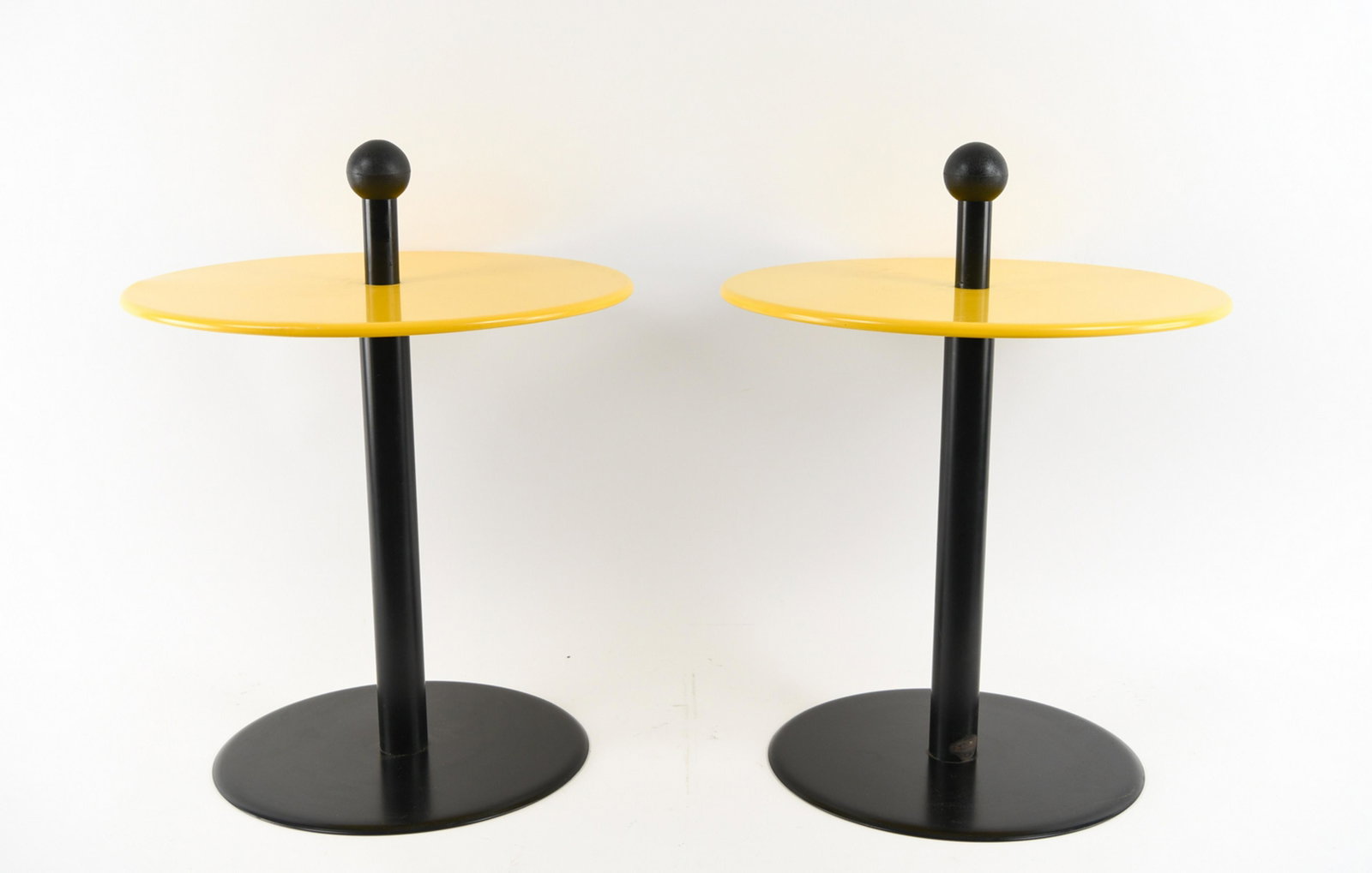 PAIR OF HERMAN MILLER YELLOW END TABLES: Peeling decal on base. Dimensions: H 26" x Dia 20" Condition: Signs of age and use including dings, rubs, and areas with paint finish wear.