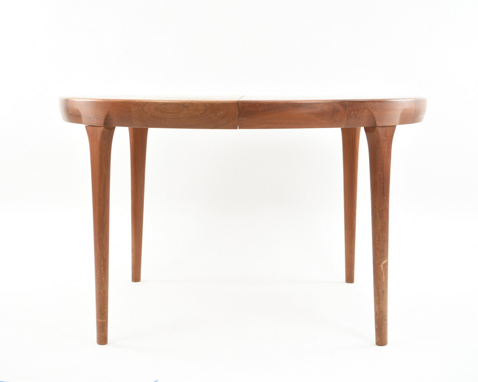 IB KOFOD LARSEN FOR FAARUP MOBELFABRIK TEAK TABLE: With (2) 19.5" leaves. Dimensions: (Without leaves) H 28.5" x Dia. 47" Condition: Light scratches and water marks to surface including light finish wear. Some rubs to sides and legs. Few scratches to