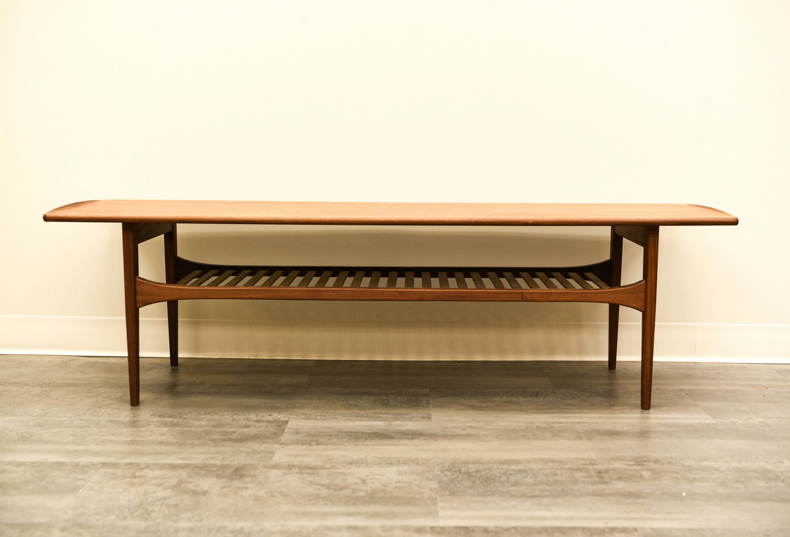 EDVARD KINDT LARSEN FRANCE AND SON COFFEE TABLE: Dimensions: H 17" x W 59.5" x D 21" Condition: Showing finish wear including a few light scratches and marks.