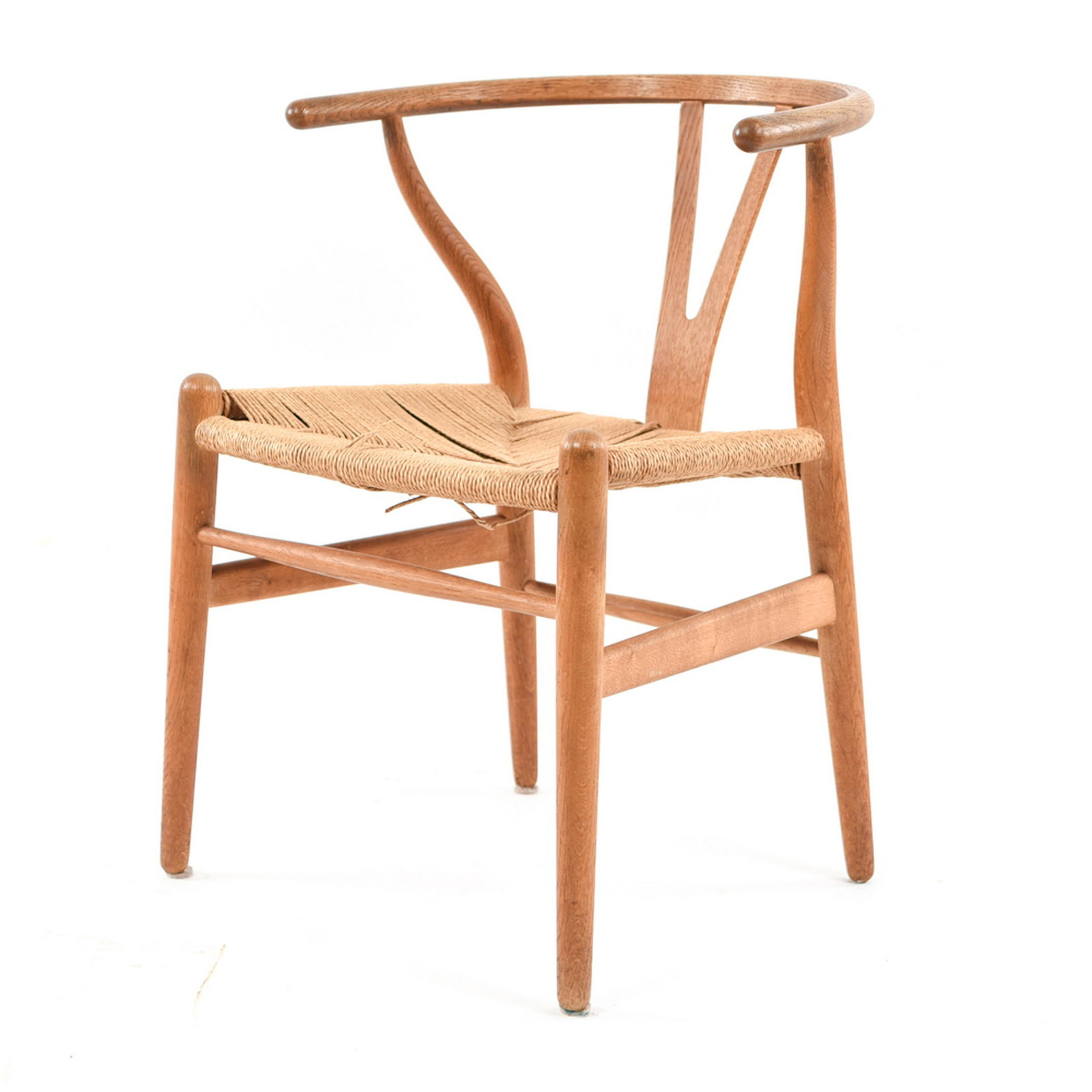 HANS WEGNER FOR CARL HANSEN WISHBONE CHAIR: With Carl Hansen label under. Dimensions: H 29" x W 19" x D 19" Condition: Some breaks and loosening of rush seat.