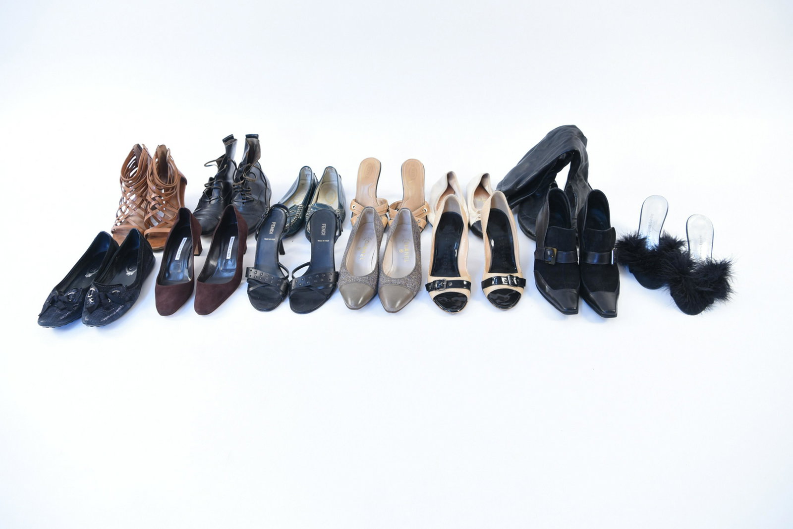 GROUPING OF LADIES DESIGNER SHOES: Including Chanel, Manolo Blahnik, Tods, Walter Steiger, etc. Sizes: Varying including 38.5, 37.5, 39. Condition: Used, showing wear including tear to one Chanel boot at seam, scuffs. All showing signs