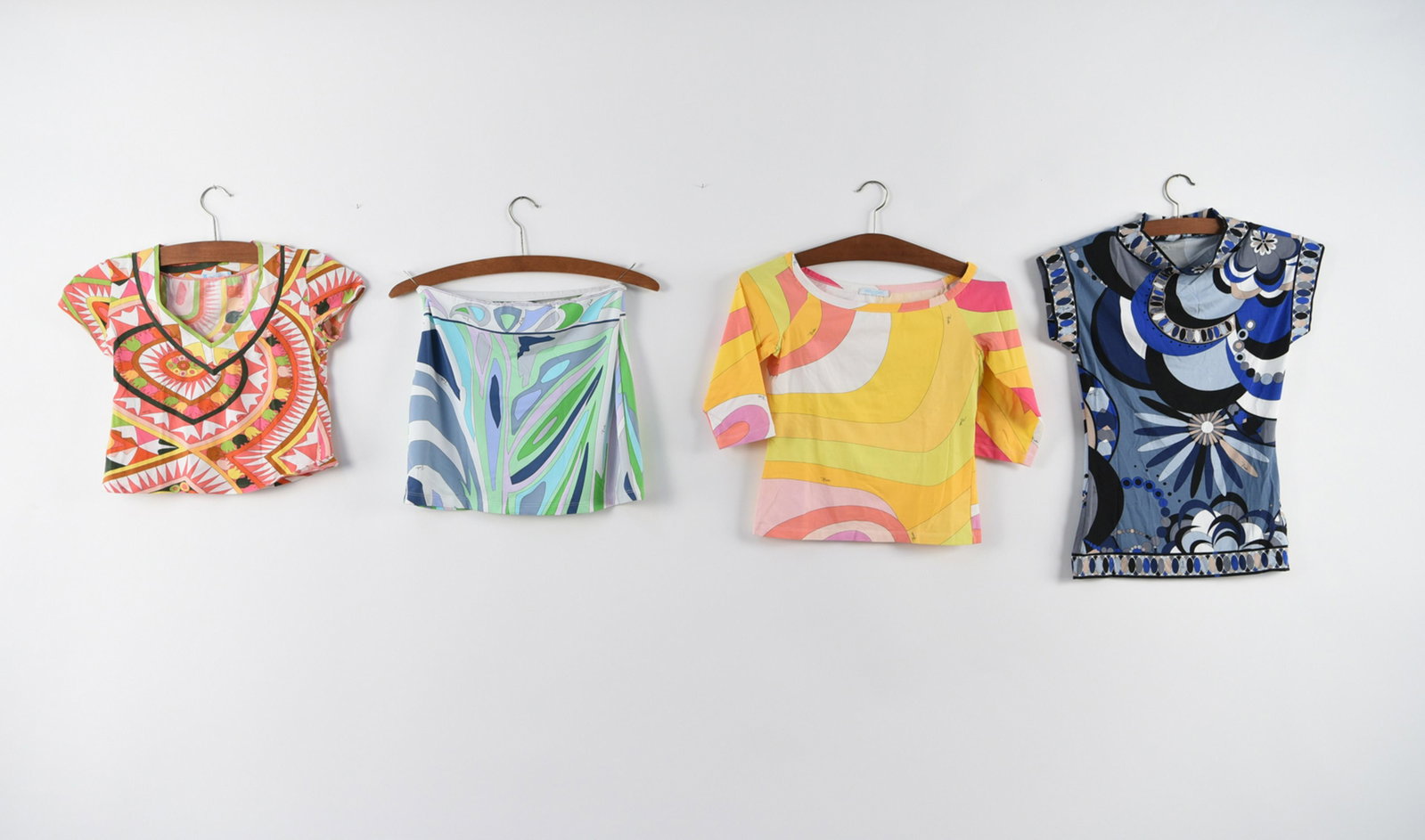 GROUPING OF EMILIO PUCCI CLOTHING: Including mini skirt (size 44), high neck blouse (size small, wide neck shirt (size 6), crop top (size 42). Condition: All lightly used, no major signs of use.
