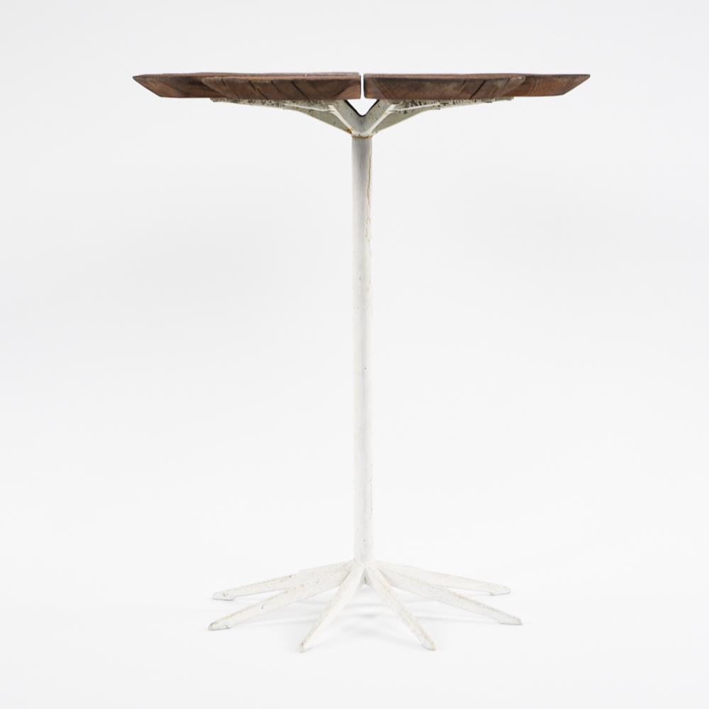 RICHARD SCHULTZ FOR KNOLL PETAL TABLE: Remnants of Knoll label underneath. Dimensions: H 19" x Dia. 15.75" Condition: Some water staining and splits to wood. Some areas of rust and paint loss to base. Showing signs of age and use.