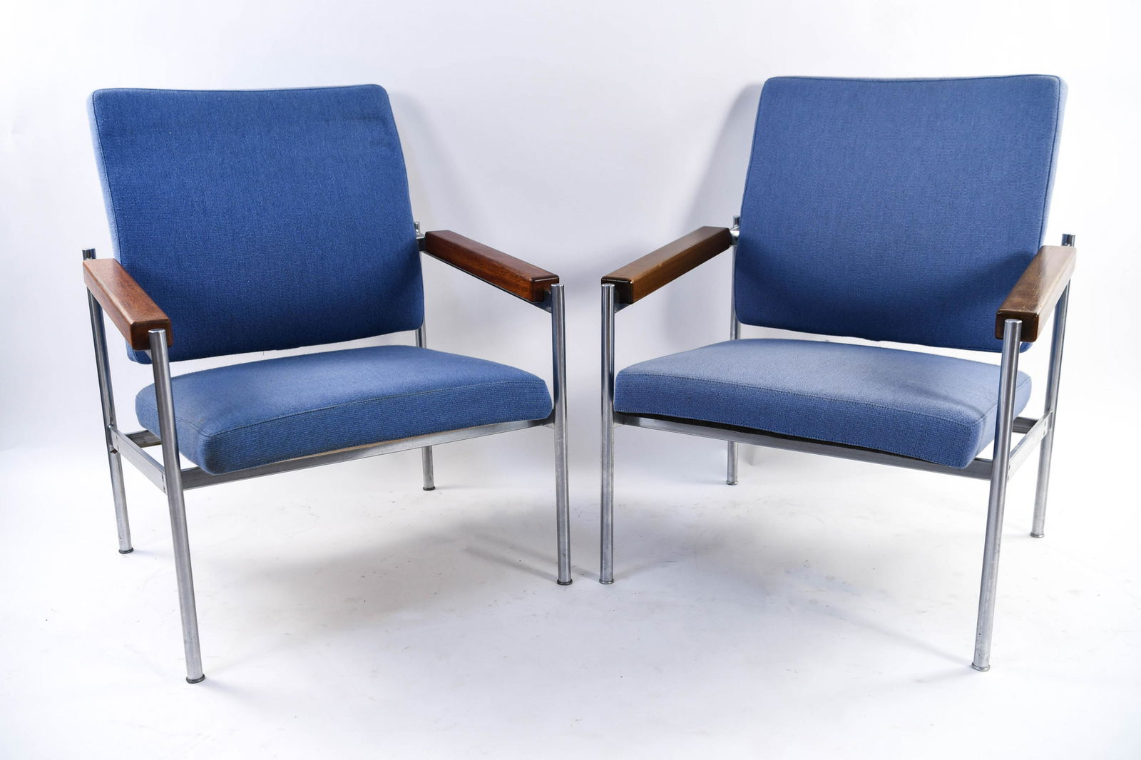 KAY BAECH HANSEN, FRITZ HANSEN LOUNGE CHAIRS: Pair of chrome and teak lounge chairs. Dimensions: H 33.5" x W 26.25" x D 27" x SH 15.5" Condition: Some fading to upholstery. Light finish wear to wood. Few small spots to upholstery. Wear consistent