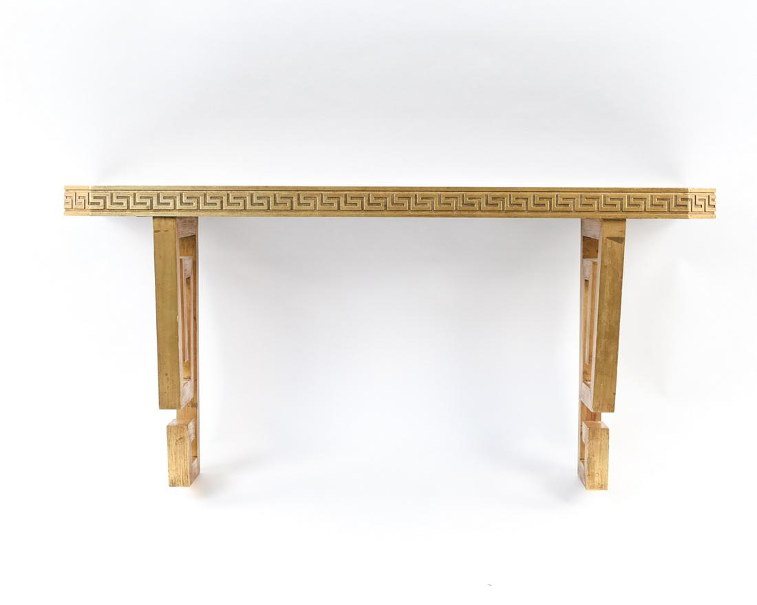 WALL MOUNT CONSOLE W/ GILT GREEK KEY MOTIF: Glass top. Style of James Mont, c. 1950s. Dimensions: H 20.5" x W 42" x D 12" Condition: Surface wear, nicks and dings. Wear consistent with age and use.