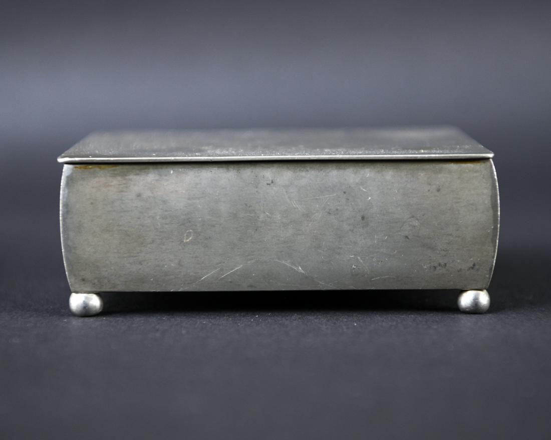 EARLY JUST ANDERSEN FOOTED PEWTER BOX: Marked underneath. With birch lining, c. 1929. Dimensions: H 2" x W 4.5" x D 3.5" Condition: Wear consistent with age and use including small dents, surface scratches.