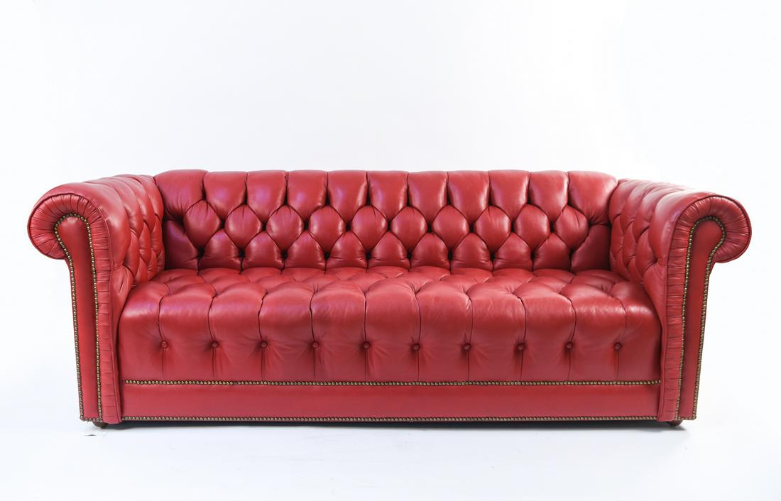 RED LEATHER CHESTERFIELD SOFA: Dimensions: H 30.5" x W 83" x D 35" x SH 17" Condition: Minor surface wear and scuffs to leather.