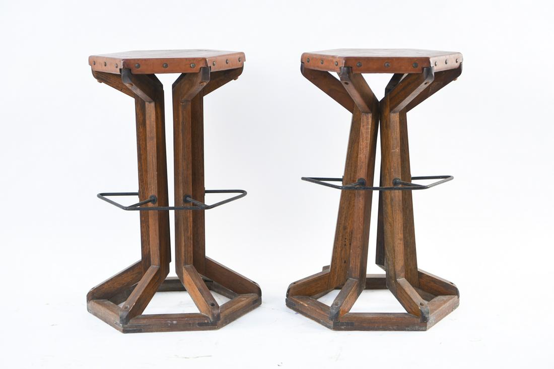 (2) ARTS AND CRAFTS STYLE BAR STOOLS: Dimensions: H 29.25" x W 17.5" x D 20" Condition: Some marks and discoloration to leather seats. Missing some pegs to bases. Overall wear consistent with age and use. Some rust to metal.