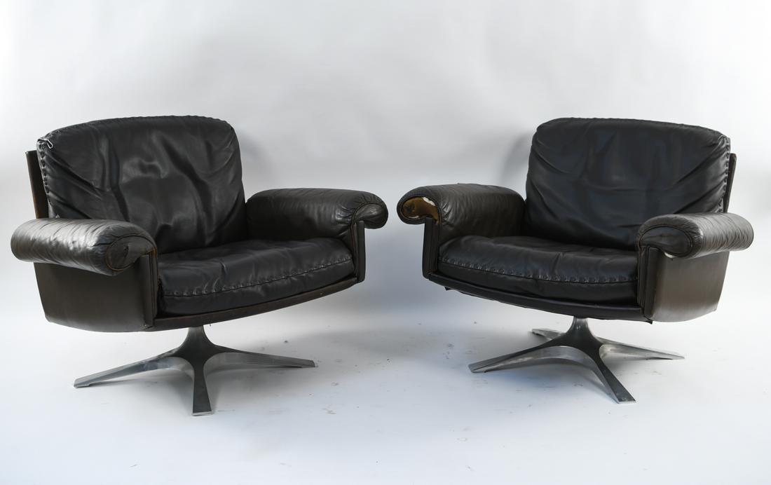 PAIR OF DE SEDE LEATHER CHAIRS: Marked on cushion lining. Dimensions: H 27" x W 35" x D 38" x SH 17" Condition: Wear and losses to upholstery.,