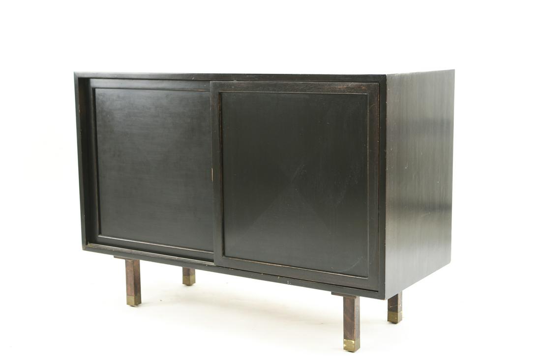 DUNBAR CREDENZA: Attr. to Edward Wormely. Dimensions: H 30" x W 42" x D 17.75" Condition: Showing signs of use including scratches and rubs. Tarnish to brass feet accents. Holes drilled into back panel. Wear to some c