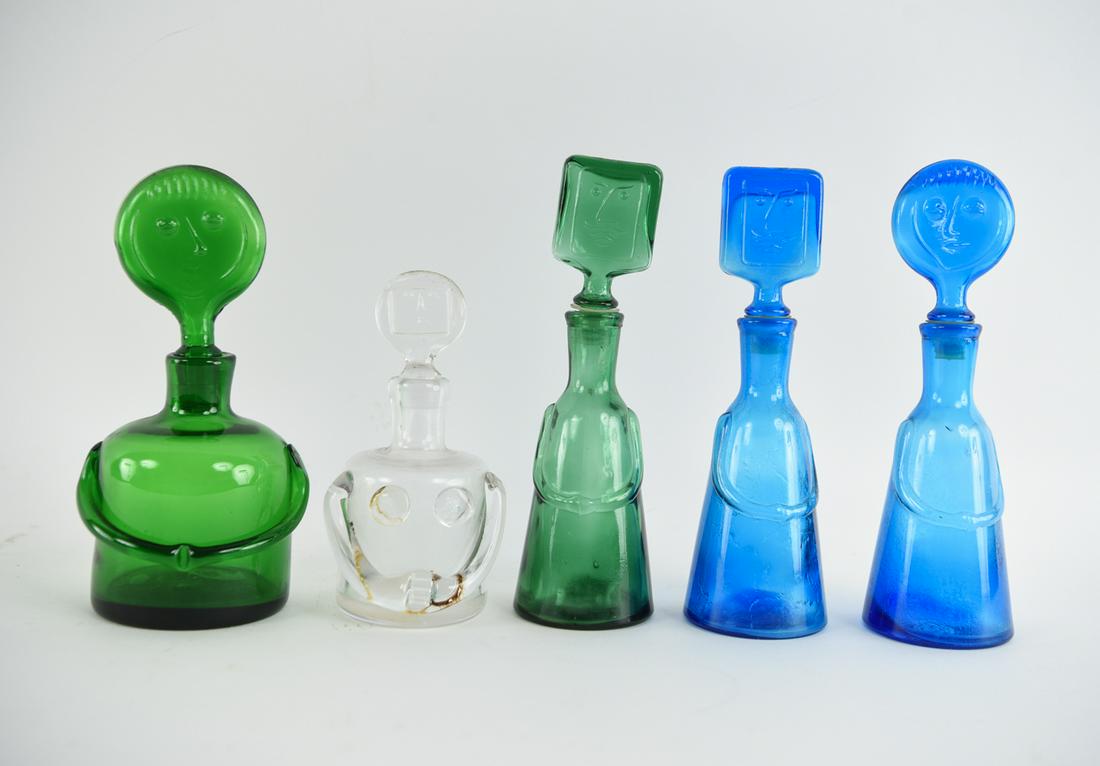 ERIC HOGLUND KOSTA BODA ART GLASS DECANTERS: 5 figural decanters. Dimensions: Tallest: H 10" x W 3" Condition: insides showing signs of use, no deterring chips or cracks.